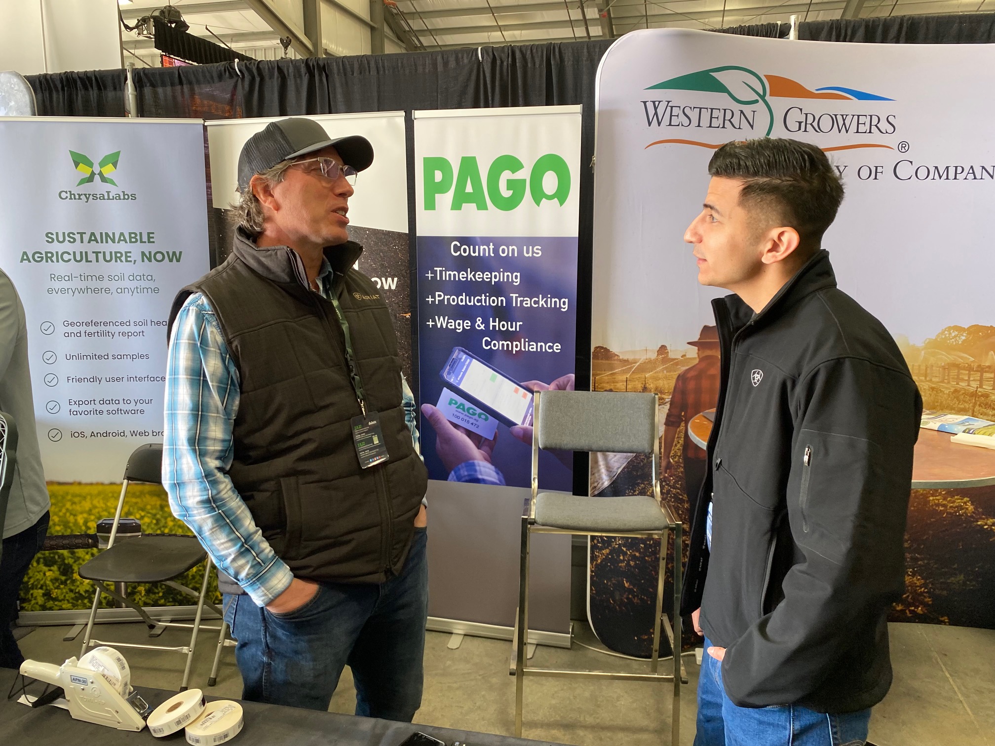  Mike Dodson, CEO of Pago talks to one of his developers about a recent meeting with growers. Pago manages timekeeping, production tracking and wage compliance for growers and farm labor contractors. 