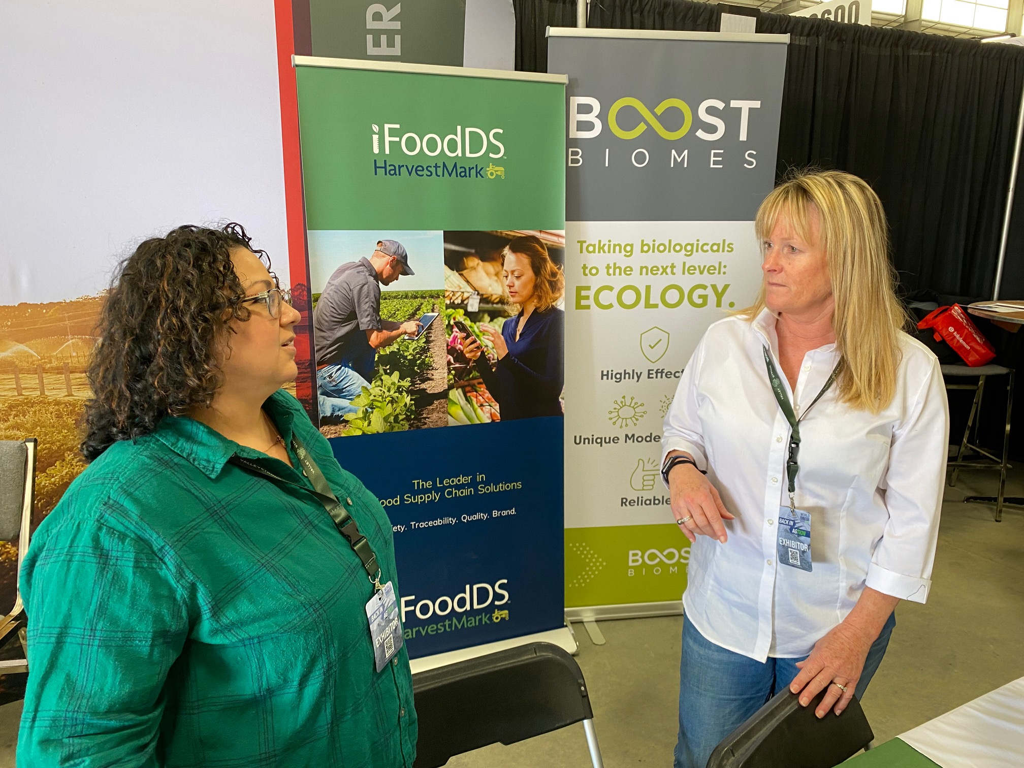  Kathy Nunez-Haldezos of iFoodDS and Johnna Hepner of Boost Biomes take a break from visitors. iFoodDS provides supply chain traceability, supporting harvesting, and packing and processing workflows. Boost Biomes develops and delivers resilient microbial solutions for crops.