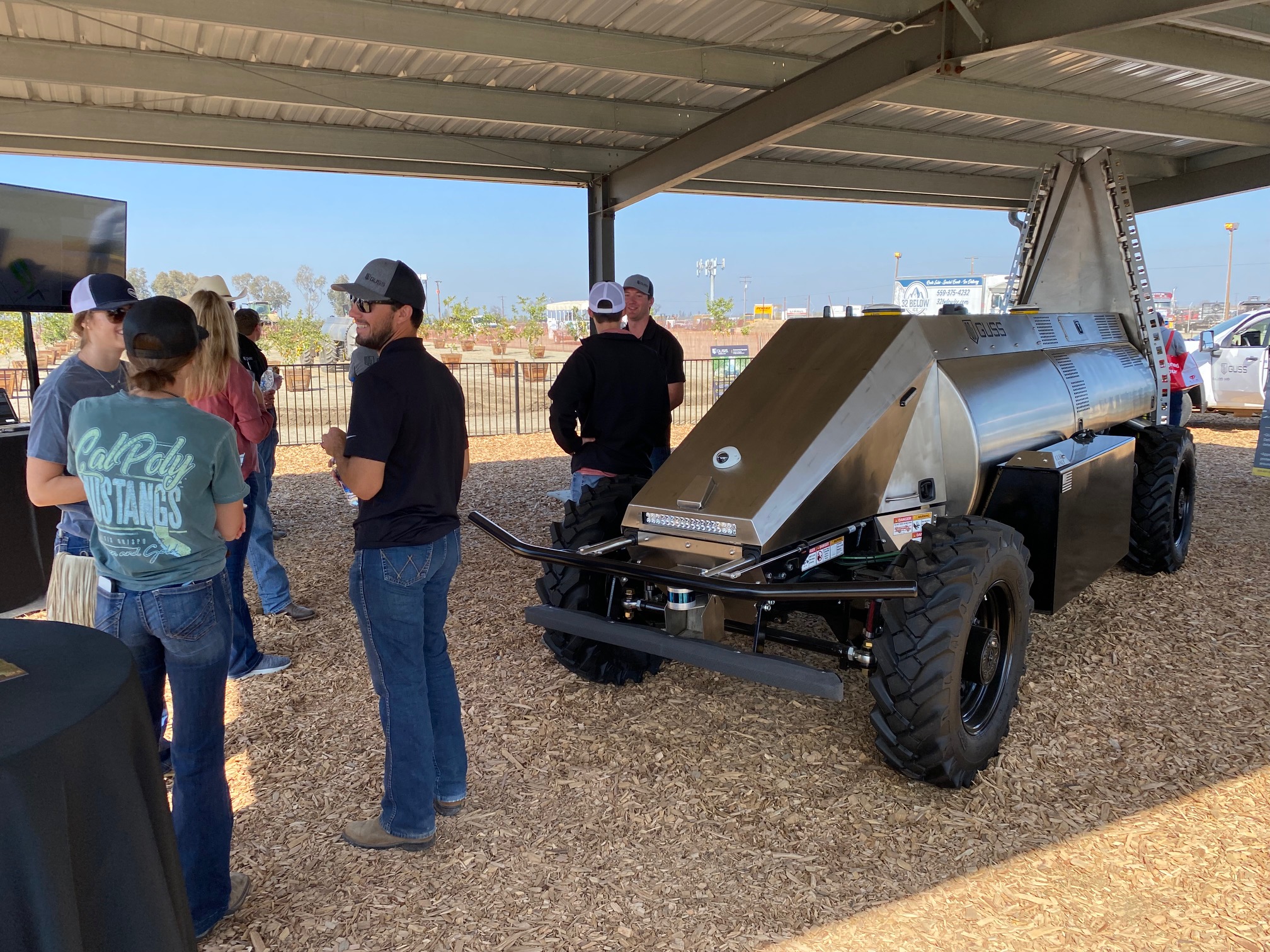  The Guss team talks to prospective customers about the company's autonomous sprayers for orchards and vineyards. The mini sprayer won one of the top-10 new products awards at the show. 