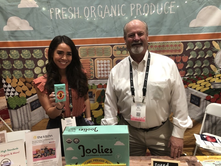  Amanda Sains, marketing director for Joolies and Neill Brassell,  East Coast food broker for Joolies, are pictured on the 2022 GOPEX show floor.  Brassell said Joolies dates, available in both organic and conventional categories,  are now in more than 3,500 stores three years after the company started. With vibrant and sustainable packaging, Joolies brings fun and excitement to the category, he said.
