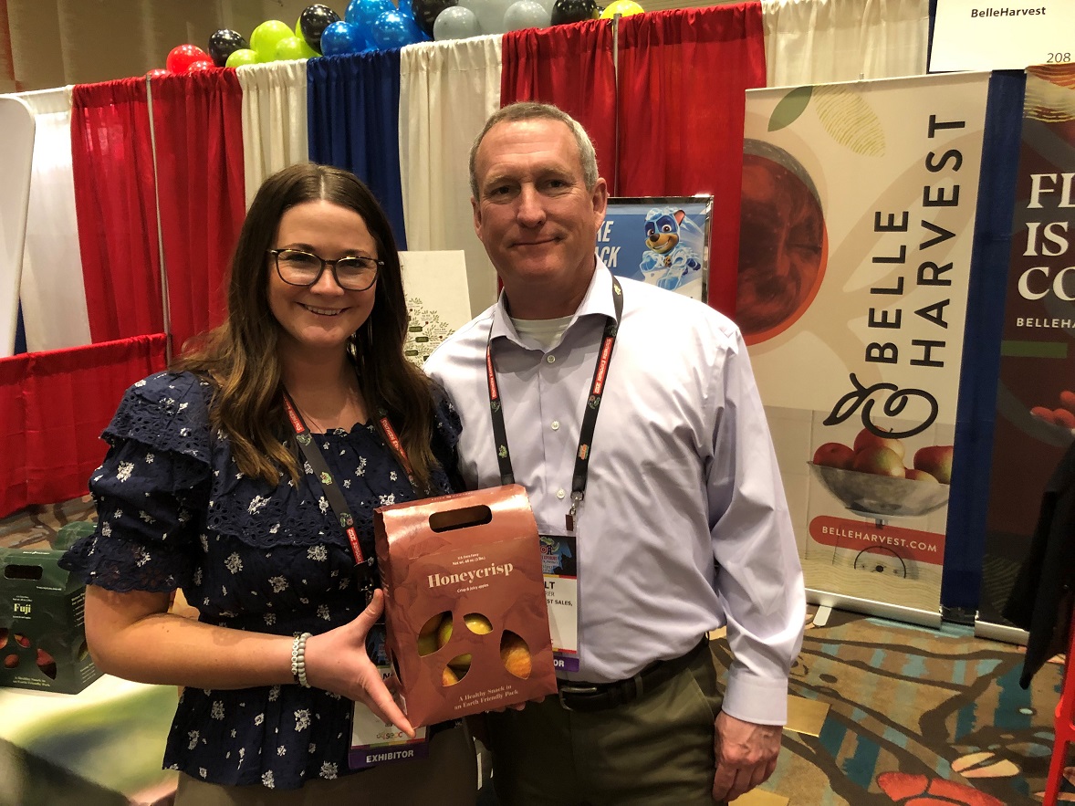  Angela Sommers, marketing director for Belleharvest Sales, Belding, Mich., and Milt Fuehrer, CEO,  display the company's sustainable pack option. 