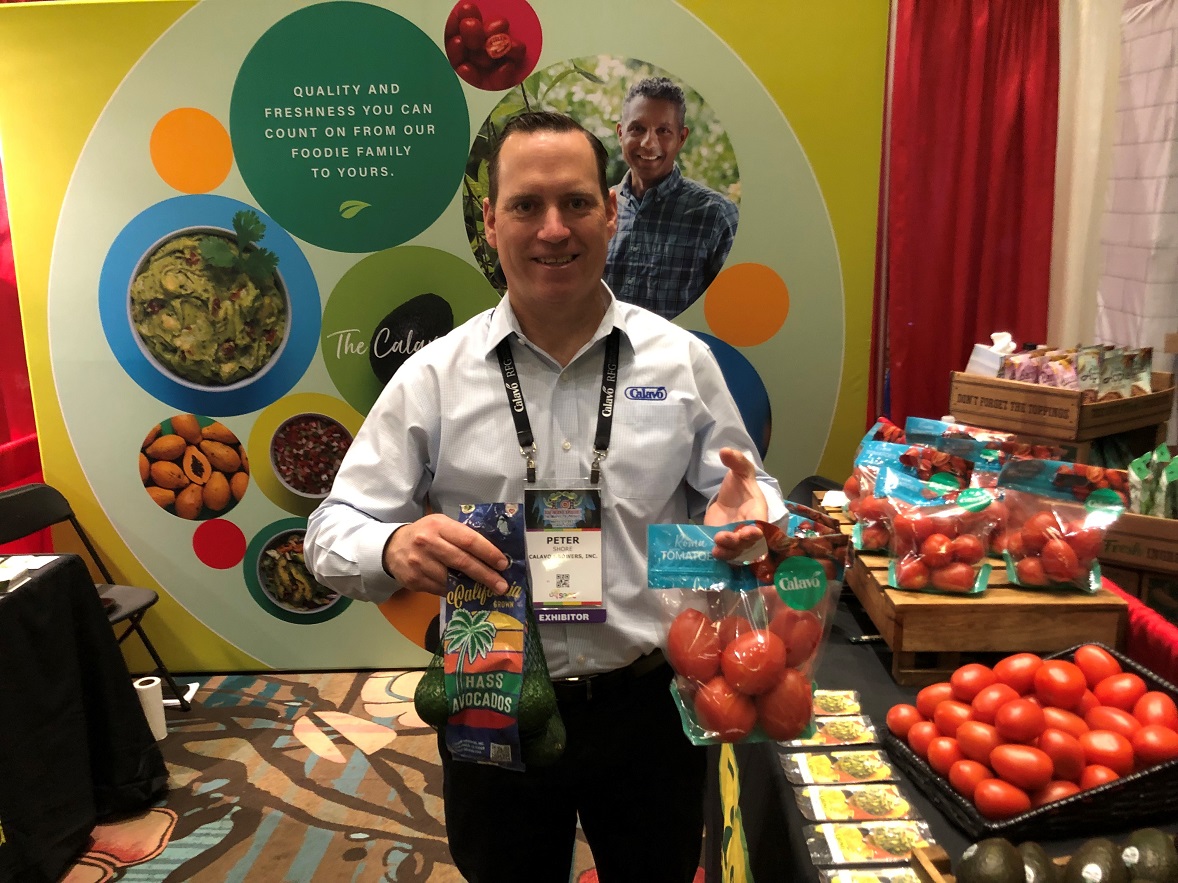  Peter Shore, director of business development and marketing for Calavo Growers, displays the marketer's California branded avocado bag and its new 2-pound roma tomato package.