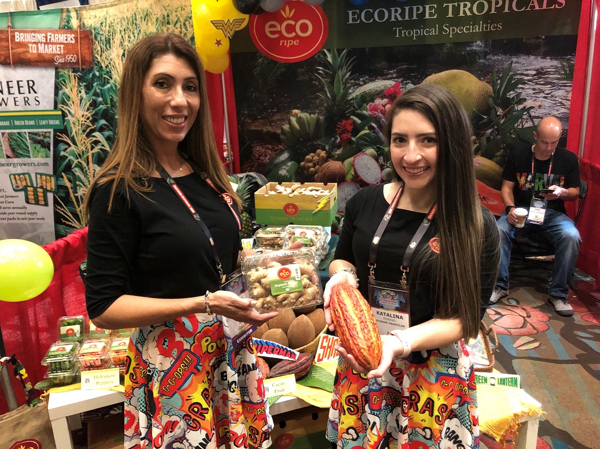  Isabel Hurtado, general manager of Ecoripe Tropicals, Medley, Fla., with Katalina Moreno, marketing and sales associate, display organic ginger from Peru and cacao fruit from Ecuador. The company also features ready-to-drink coconuts from Costa Rica that can be customized with laser-etched logos, Hurtado said.