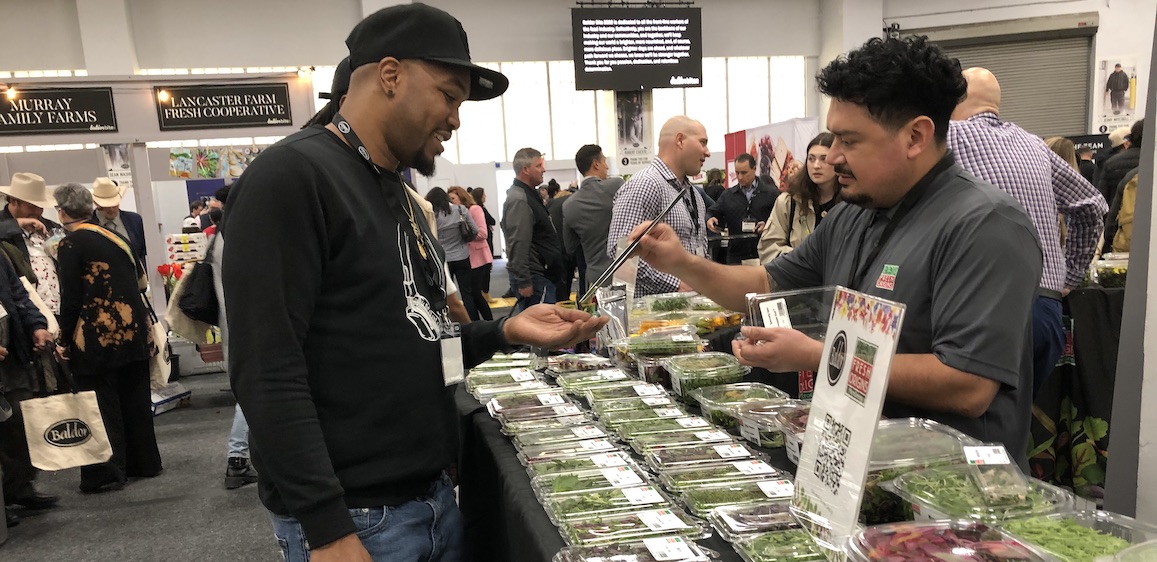  Chef Brian George of the French-American Reserve restaurant samples the green apple sorrel from the Fresh Origins microgreens booth at the April 26 Baldor Bite show in New York City.