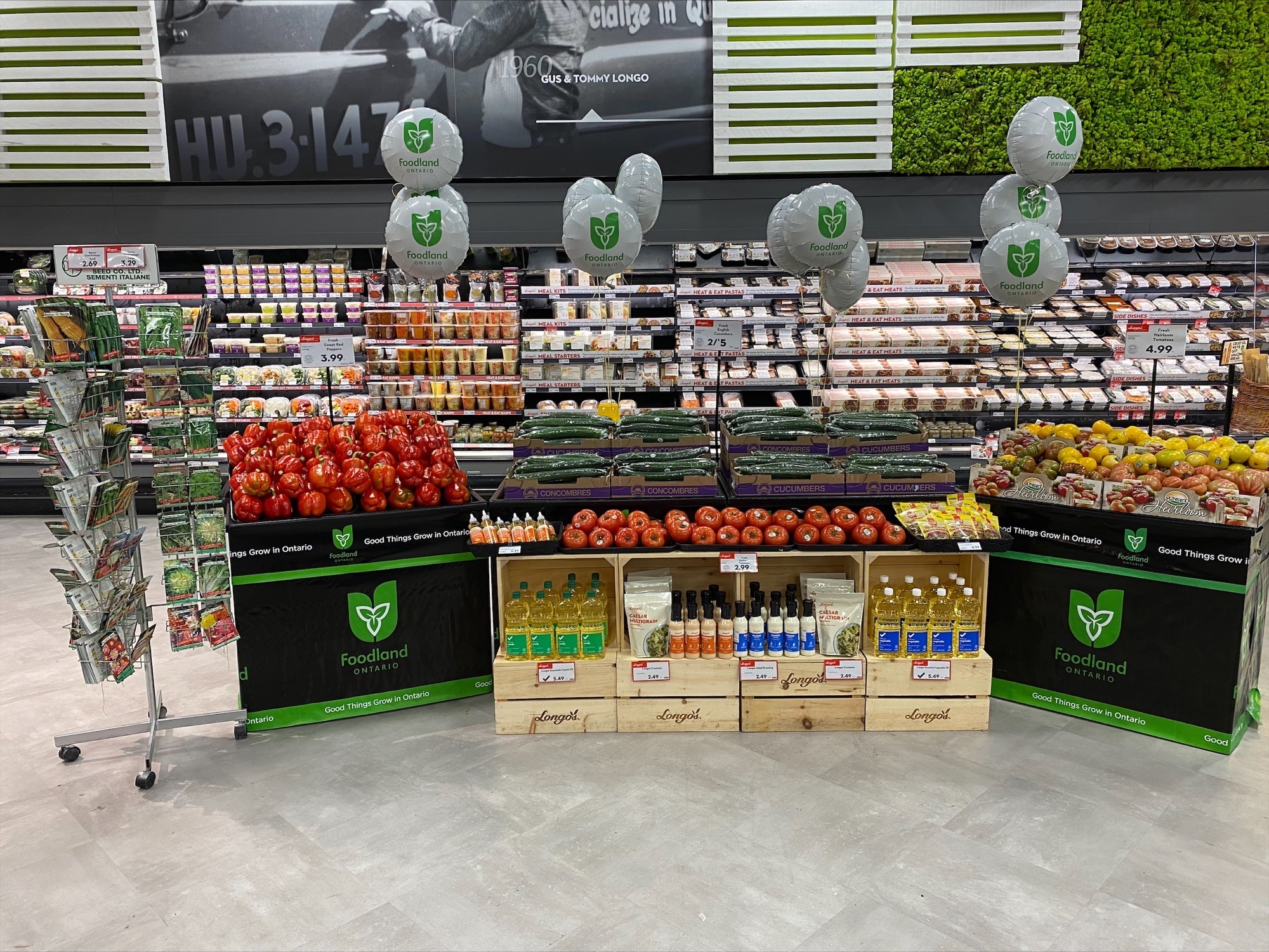  The cucumber, bell pepper and tomato produce merchandising display at Longo's Walkers Line features a seed packet stand next to the display. And did you notice the cross-merchandising of oils and dressings?