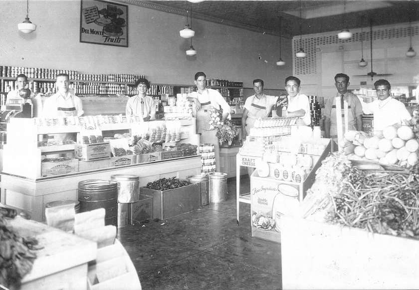  Bashas' supermarket employees in Chandler, Ariz., from the early 20th century stand near the grocery and produce bins. Photos: Courtesy of Bashas'