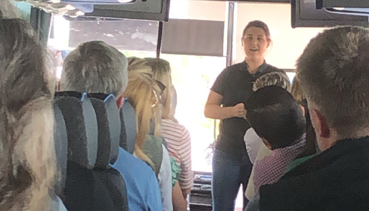  Meghan Diaz, director of local and regional on the East Coast at Sprouts Farmers Market, introduces herself to the tour bus riders.