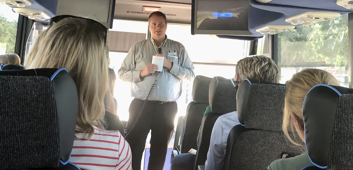 Earl McGrath, produce operations director of Freshfields Farm, introduces himself to the retail tour crowd on the bus.