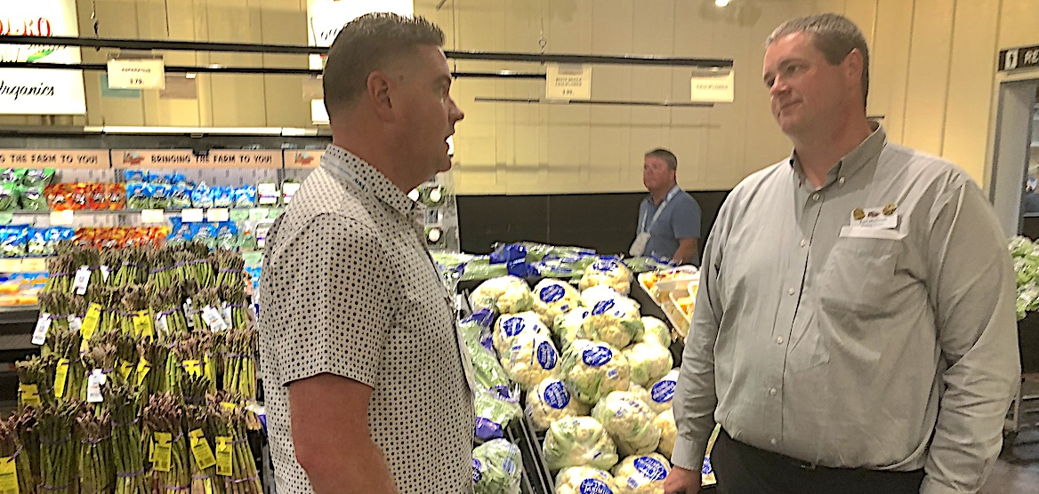  Casey Rose, senior director of sales and product business management at Driscoll's (left), talks with Earl McGrath, director of produce operations at Freshfields Farm, on the retail tour.