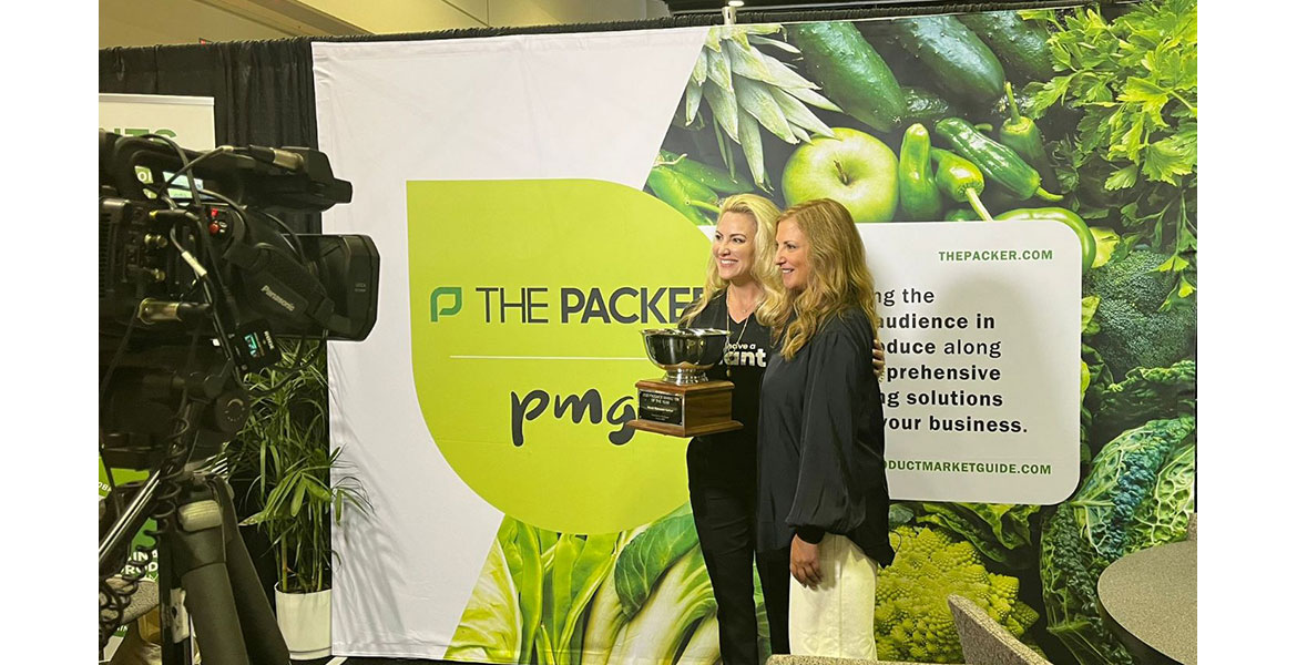  Jennifer Strailey, editorial director of The Packer,  presents the 2022 Produce Marketer of the Year award to Wendy Reinhardt Kapsak, president and CEO of Produce for a Better Health.