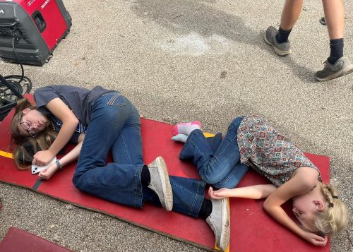 Mallory Homann and Harper Shike asleep at IL State Fair