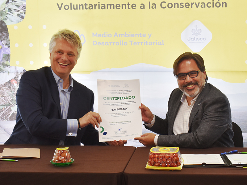 NatureSweet President and CEO Rodolfo Spielmann receives the voluntarily protected area certification from an official with the state of Jalisco in Mexico.