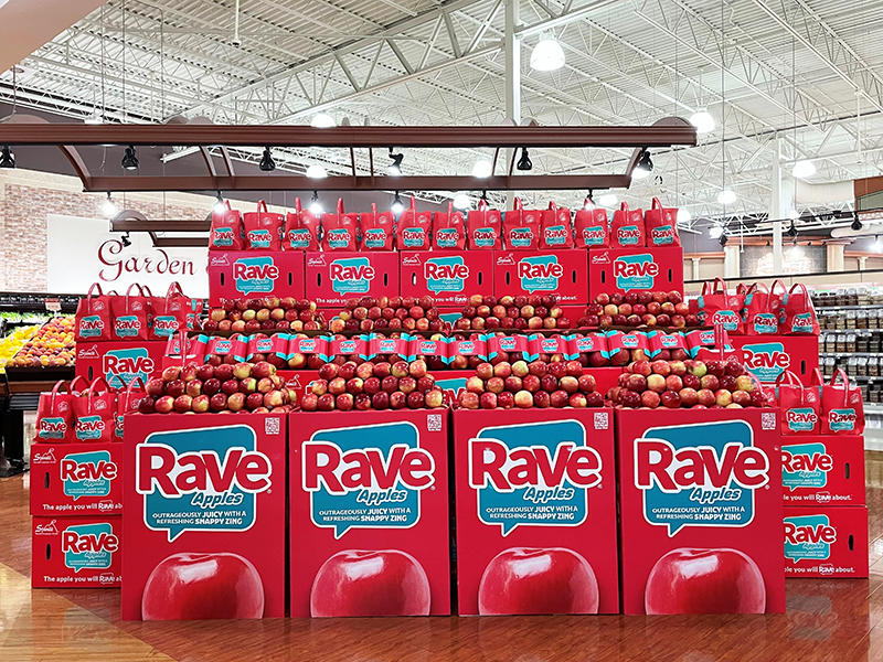 A bin display of Rave apples in a store grocery department
