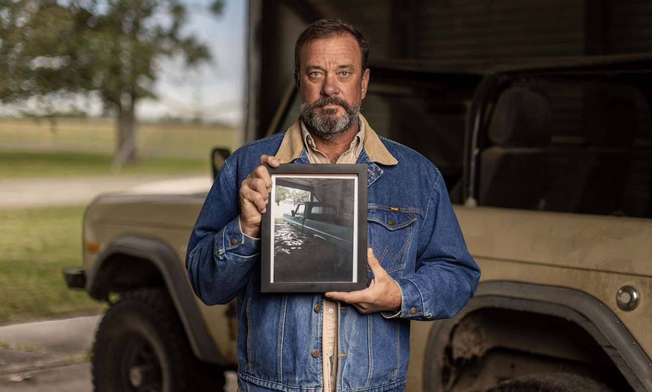 Farmer Fights for Justice, Holding Photo