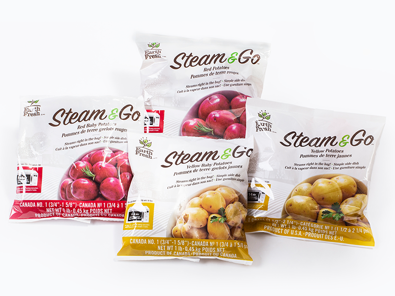 There are four bags of EarthFresh brand Steam & Go potatoes — two with red potatoes and two with yellow potatoes. The background is white.