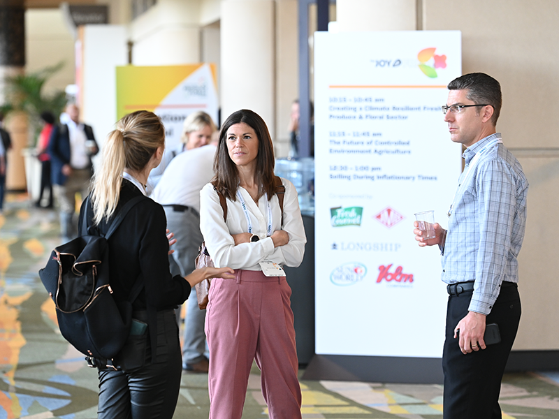 A group of people chat during the 2022 IFPA Global Produce & Floral Show