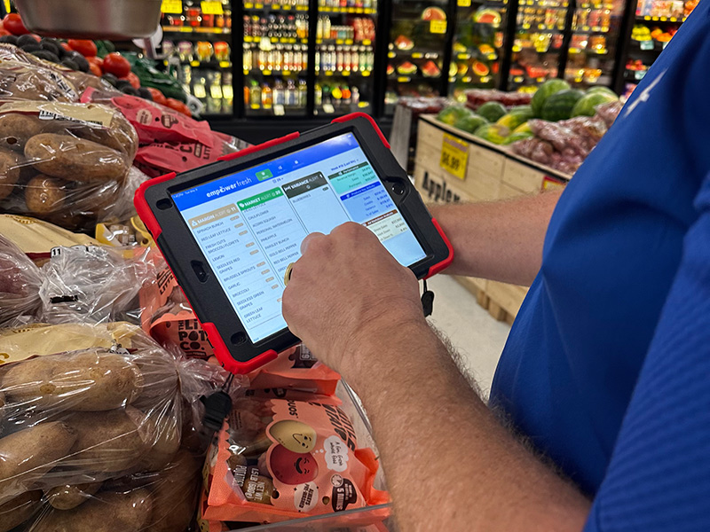 Tablet with software being used in a produce department.