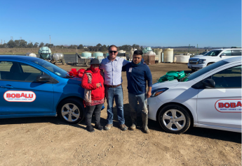 RC Jones (center), managing member of Bobalu Berry Farms, with workers Guillermo and Eva, who won cars at the company's end-of-season celebration for strawberries.