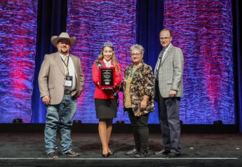 Adam Sawyer, A & B Cattle; Eva Hinrichsen, Miss American Angus, presenting; Becky Sawyer, A & B Cattle; and Mark McCully, American Angus Association CEO.