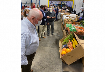 Agriculture Secretary Sonny Perdue (foreground) participates in a Farmers to Families Food Box Event at the Athena Farms facility at the Atlanta State Farmers Market in Forest Park, Ga., on June 1.