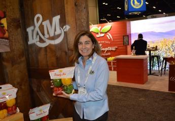  Lee Anne Oxford, director of marketing for L&M Farms, Raleigh, N.C., displays the firm’s Simply Sun Peppers.