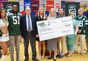 On hand for a $20,000 check presentation to Ocean Township Intermediate School were Jets Flight Crew member Jenna (from left), Jets linebacker Brandon Copeland, New Jersey Secretary of Agriculture Douglas Fisher, Jets community relations assistant Maddy Brown, Ocean Township Schools Sodexo foodservice manager Jackie Wagner, physical education teacher John Dellapesca, NJDA school nutrition programs marketing specialist Jackie Bricker, school principal Larry Kostula, and American Dairy North East marketing representative Aisha King.