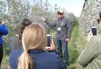 Neal Carter, founder and president of Okanagan Specialty Fruit, leads a tour at an orchard of Arctic apples last October. The company invited produce industry media, bloggers and food writers to explain how the genetically engineered apples were developed, and to talk about plans for increased production.