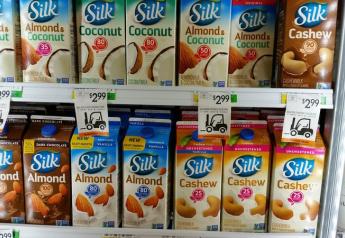 Shot of grocery store cooler loaded with various "Silk" brand of plant-based milk-like products, almond, coconut, cashew, almond