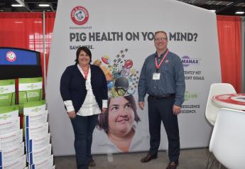 Ellen Davis, ARM & HAMMER swine technical services manager, (left) and Steve Larsen, Passport Food Safety Solutions, (right) welcome attendees of the Iowa Pork Congress.