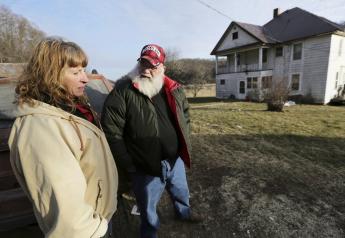 Julie and Phil Henneman, who lost their son Keith to suicide in 2006, when he was 29, talk about the experience outside the old farmhouse in Boscobel, Wis. The Hennemans continue to live on the 215-acre farm with two other sons, but they aren't farming. 