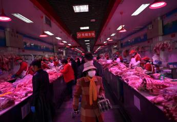 Customer wearing face masks buy pork meat at a wholesale market for agricultural products, as the country is hit by an outbreak of the novel coronavirus, in Beijing, China February 19, 2020. REUTERS/Tingshu Wang
