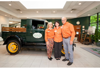 At an event celebrating Kegel's Produce's 70th anniversary, President Suzanne Myers (from left), Dawnne Monka, assistant to the chief operating officer, and Kenny Myers, chief operating officer, pose with a vintage truck.