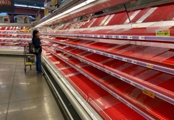 An empty grocery store meat case in March.