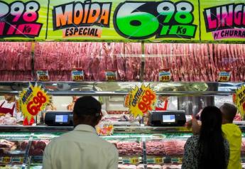 Customers buy meat from at a butchery stall inside a market in Sao Paulo, Brazil, on Saturday, March 18, 2017.
