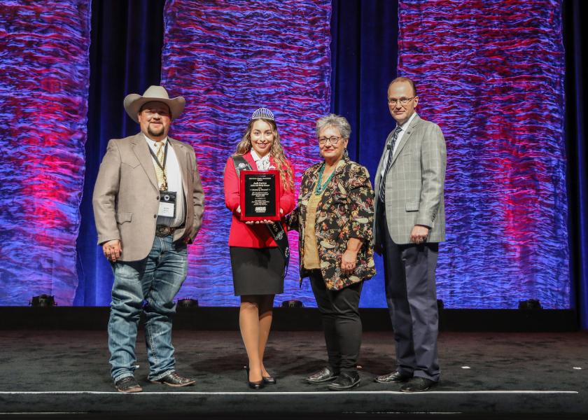 Adam Sawyer, A & B Cattle; Eva Hinrichsen, Miss American Angus, presenting; Becky Sawyer, A & B Cattle; and Mark McCully, American Angus Association CEO.