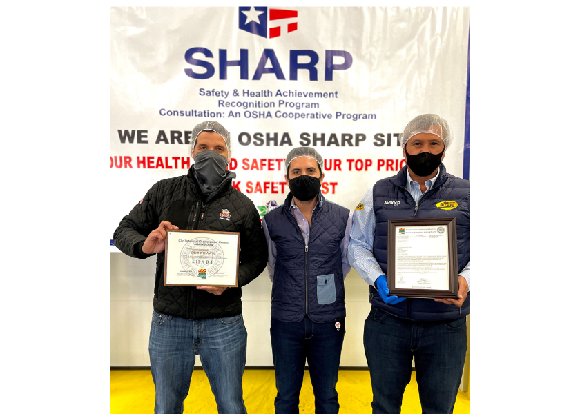 Carlos Bon (from left), vice president of sales at Divine Flavor; Jose Antonio Martinez, general manager; and Alan Aguirre, president and CEO, at a ceremony celebrating the company's health and safety management systems.