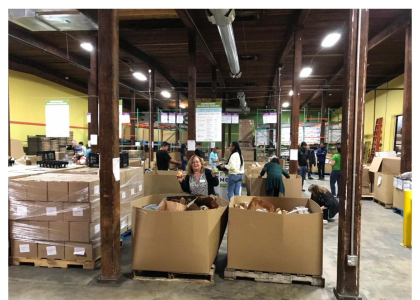 Allen Lund Co. employees help package food for Feedmore in Richmond, Va.