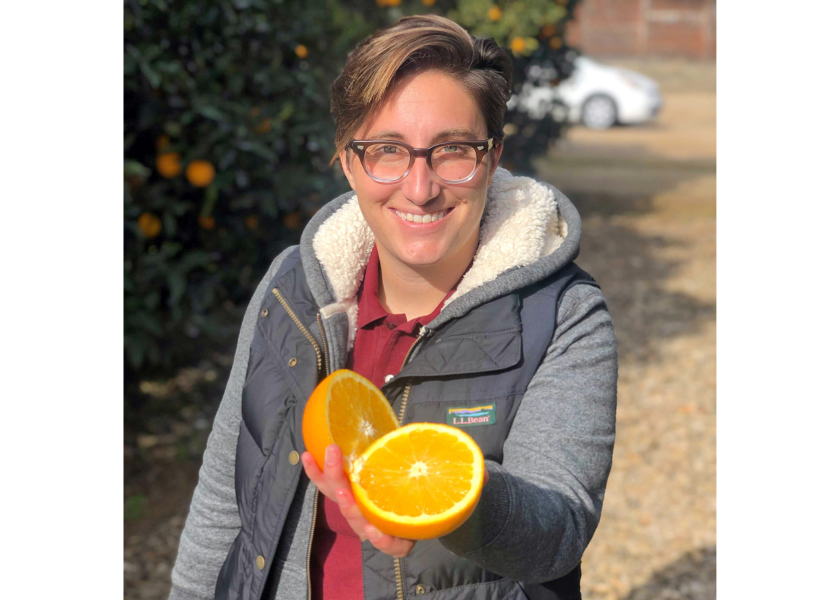Bianca Kapreilian, CEO and co-founder of Fruit World, Reedly, Calif., with a navel orange.