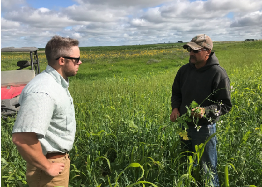 Ducks Unlimited field staffer works with a farmer to implement cover crops.