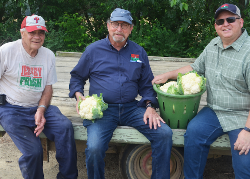 Bertuzzi Farm Market owner Joe Jacobs, New Jersey Secretary of Agriculture Doug Fisher and the department's marketing and development division director, Joe Atchison III sit on a wagon with the some freshly cut Jersey Fresh cauliflower during the promotion event.