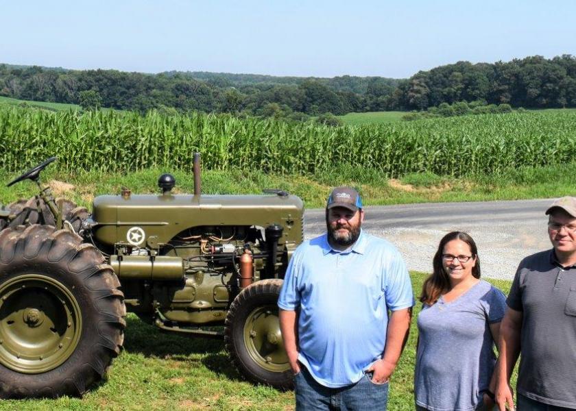Dan Jr., Erin, and Ben stand beside a pristine 1944 Case LAI Military tractor—a family restoration completed under the guidance of their father, Dan Magness, Sr. 