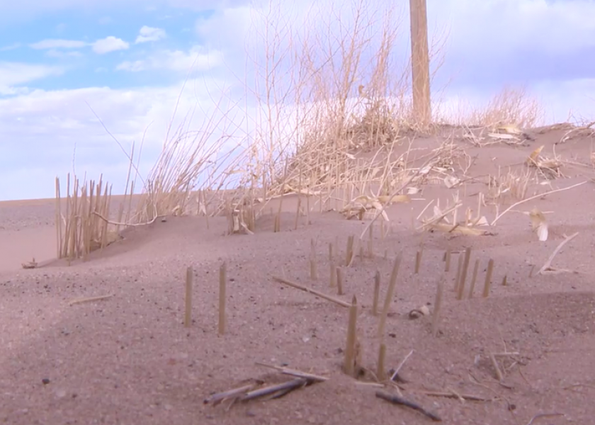 The aftermath of Tuesday's winds were evident, with drifts of dirt piled up in ditches.