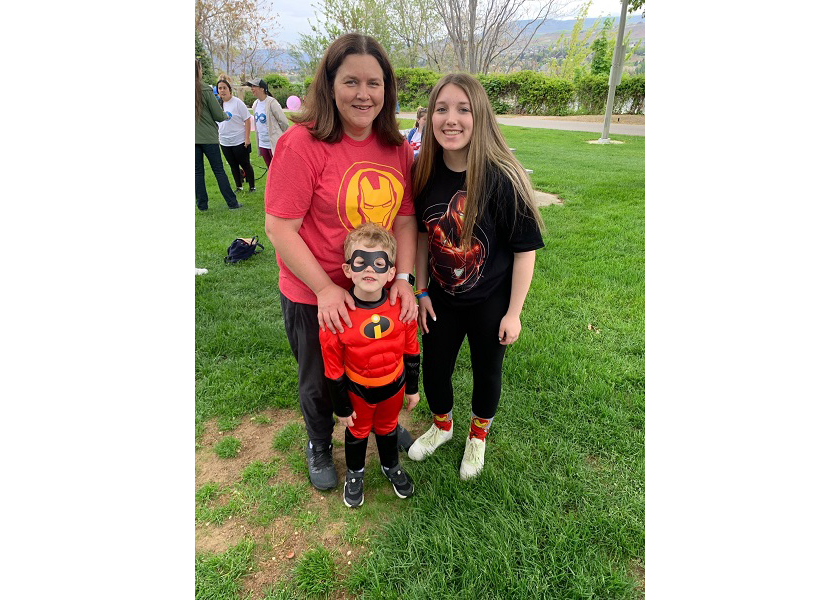 Mandy Hanko(left), sales representative with Stemilt Growers with a family at the  Brave Warrior Project’s 5th annual Superhero Walk on May 15.