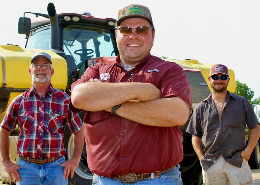 “I know I have a mighty big family wanting me to do good—and I’m not only talking blood family. I’m talking about my farming family,” says Cody Parker, flanked by Chuck Edwards, left, and Nic Williams, right. 