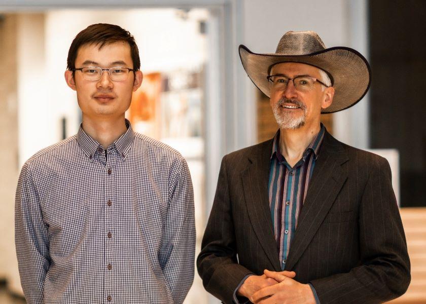 Professor Jacek Koziel, research leader on a project using ultraviolet light to improve air quality, with graduate student Peiyang Li (left), assisting with the study. 