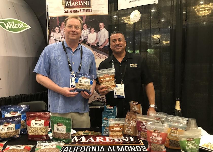 While at PMG and The Packer’s 2022 West Coast Produce Expo, Brad Ryan (left) and Darryl Bollack of Mariani Nut Co. highlight the different nut varieties and value-added flavors the company has to offer.