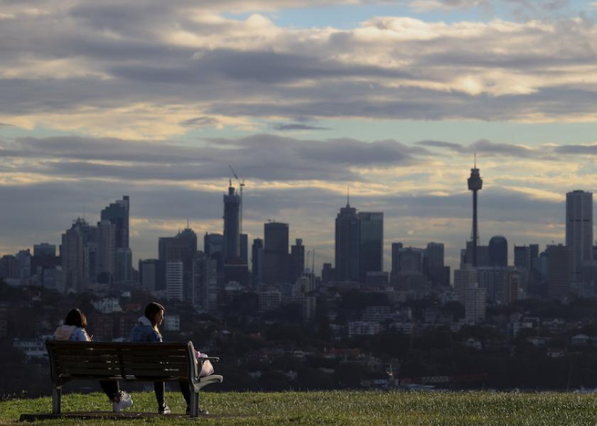 People sit on a bench overlooking the city centre skyline amidst the easing of the restrictions implemented to curb the spread of the coronavirus disease (COVID-19) in Sydney, Australia June 29, 2020.