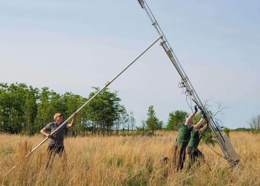 Researchers assemble energy flux monitoring towers.