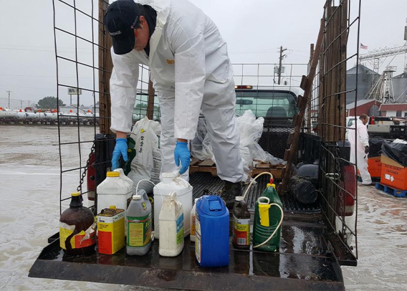 Hazardous waste contractor unloading unwanted pesticide from a participant’s vehicle at the Jefferson City, Mo., pesticide collection event. 