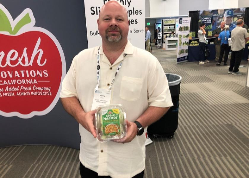 Henry Webb, sales manager for foodservice for Stockton, Calif.-based Fresh Innovations California LLC, displays the firm’s Apple Nachos pack at the IFPA Foodservice Conference on July 29.